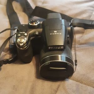 Fuji film finepix s camera with case and tripod.